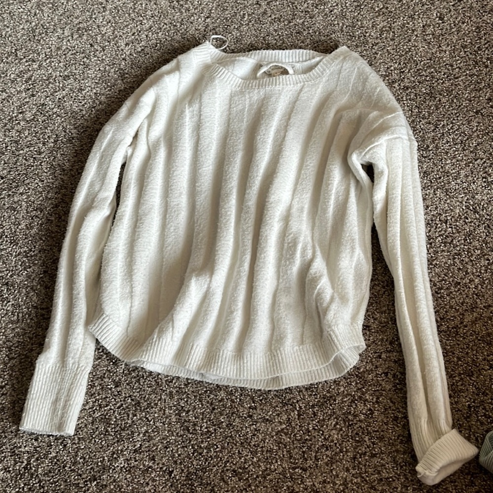 Cute plain white sweater with a fun back.